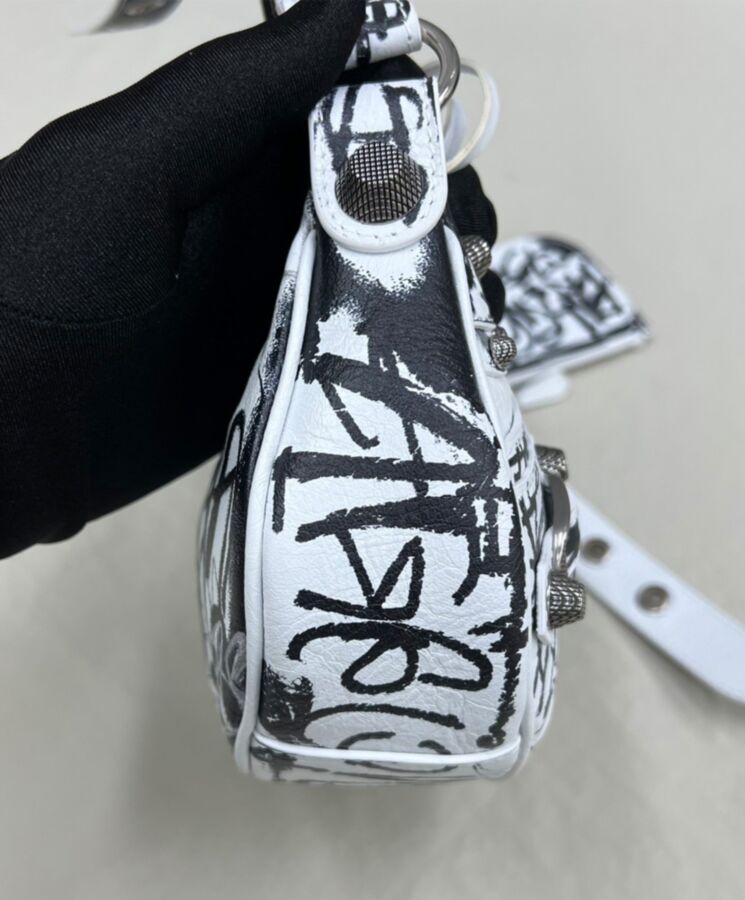 Balen.ciaga Le Cagole, streetwear style, distressed leather bag, graffiti shoulder bag