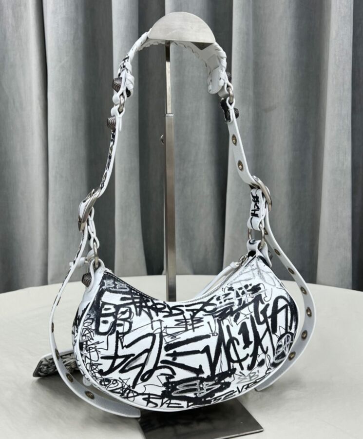 Balen.ciaga Le Cagole, streetwear style, distressed leather bag, graffiti shoulder bag